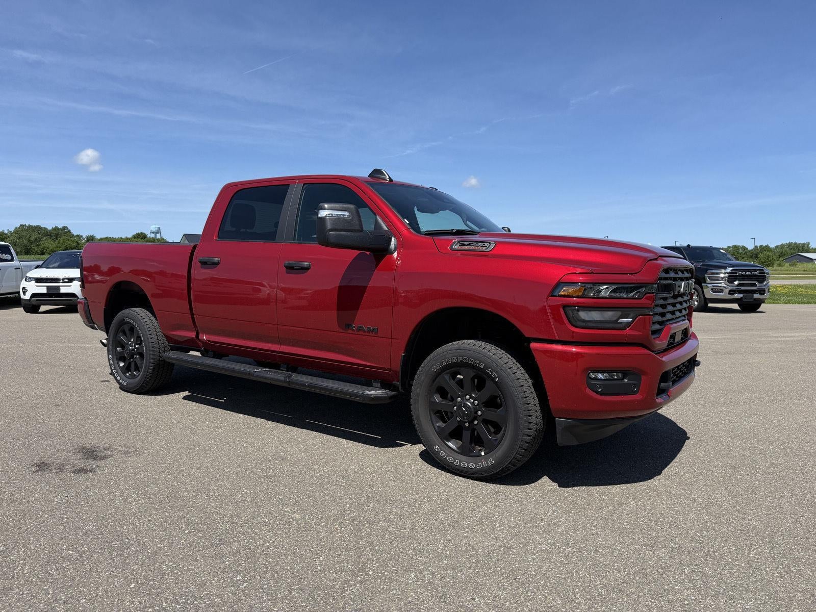 2026 RAM 2500 Big Horn in Molten Red Pearlcoat — front three-quarter view
