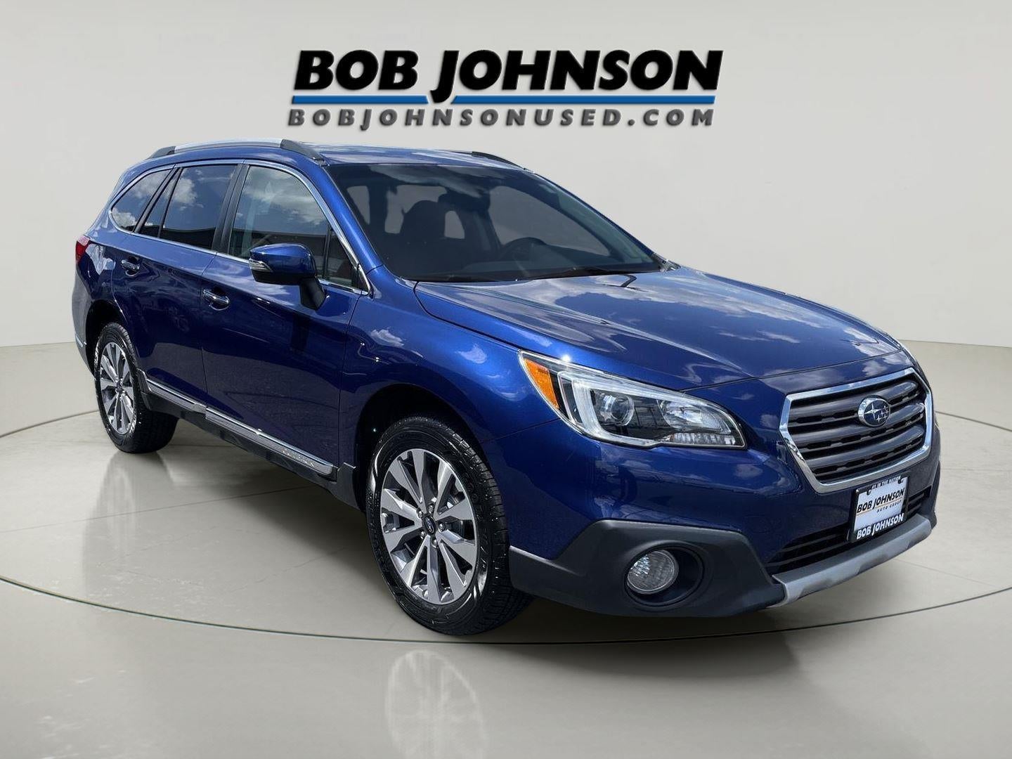 2017 Subaru Outback Touring in Lapis Blue Pearl — front three-quarter view