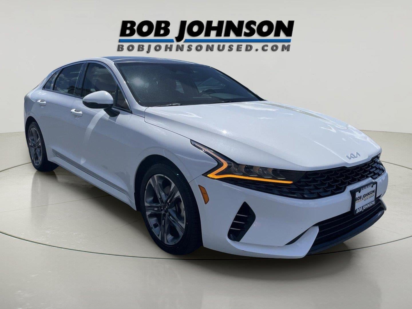 2023 Kia K5 EX in Glacial White Pearl — front three-quarter view