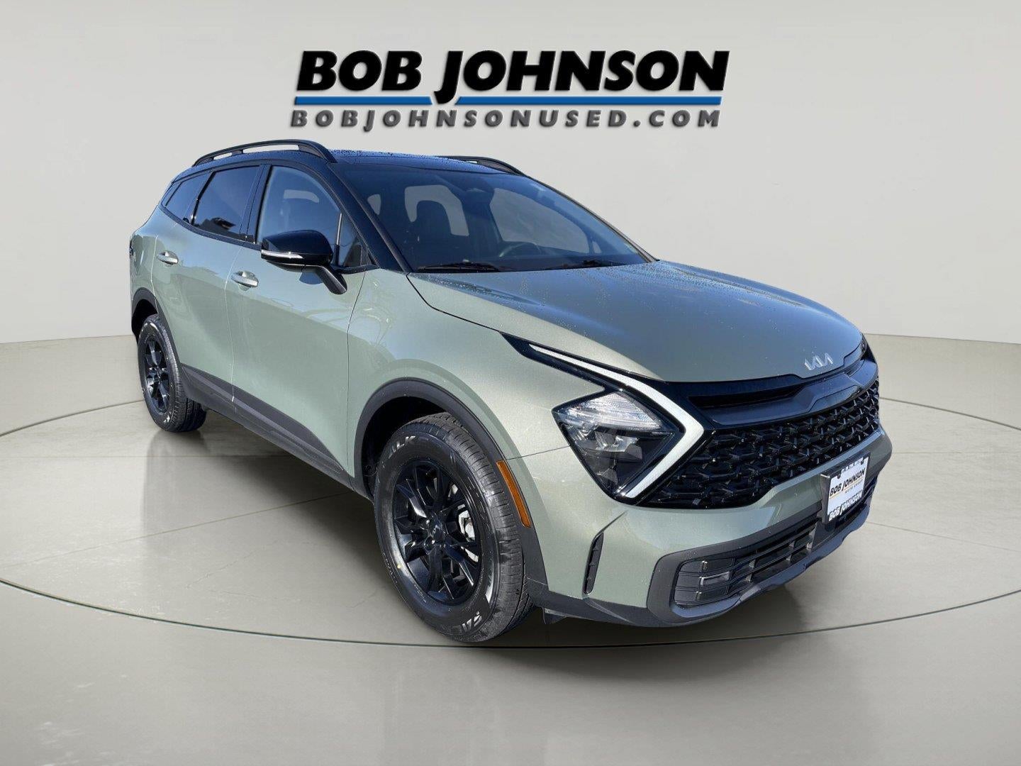 2023 Kia Sportage X-Pro in Jungle Green And Ebony Black Roof — front three-quarter view