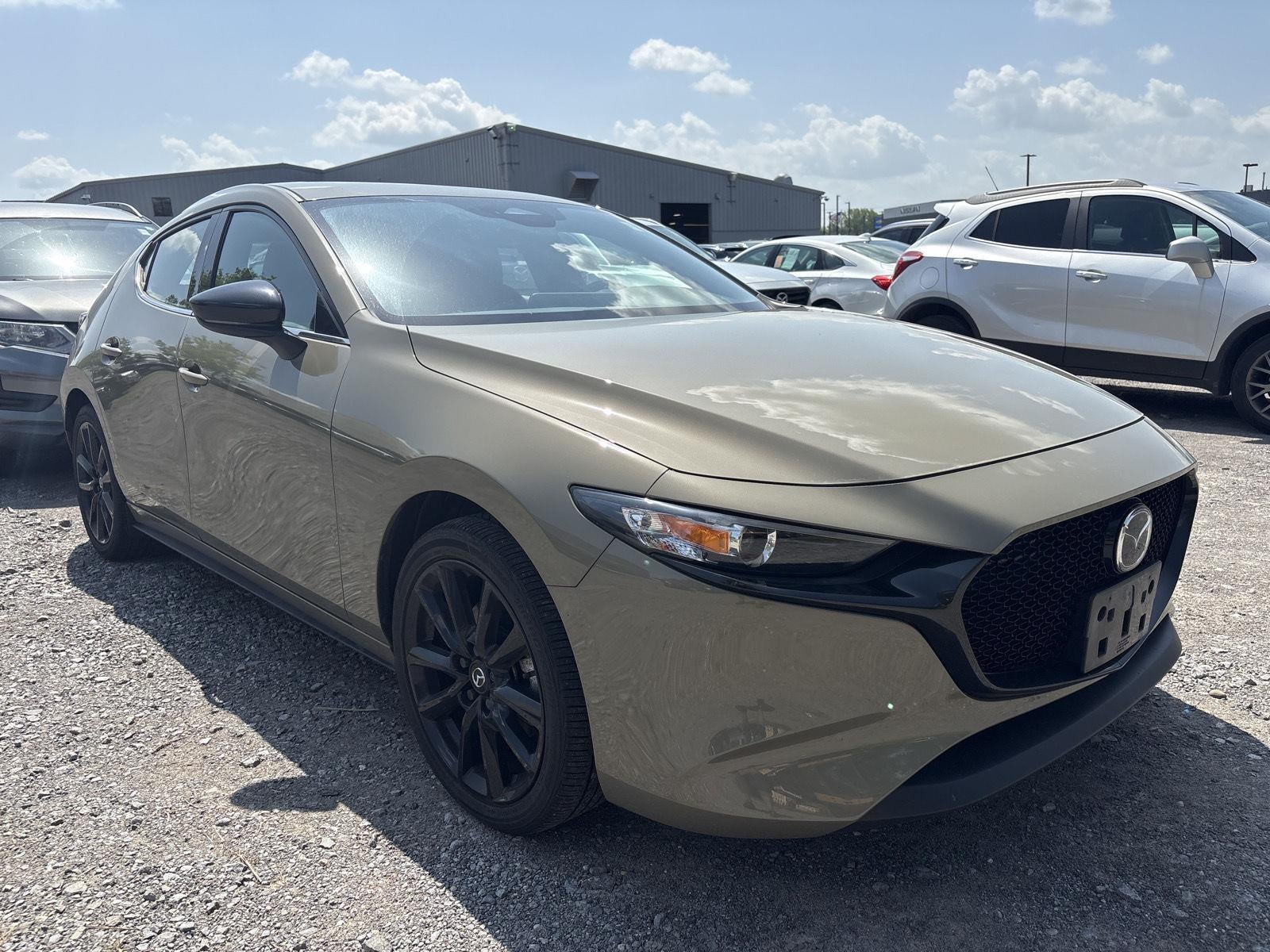 2024 Mazda Mazda3 Hatchback 2.5 Carbon Turbo in Zircon Sand Metallic — front three-quarter view